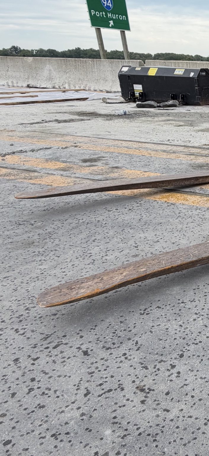 Close-up of the telehandler fork showing significant downward deformation
