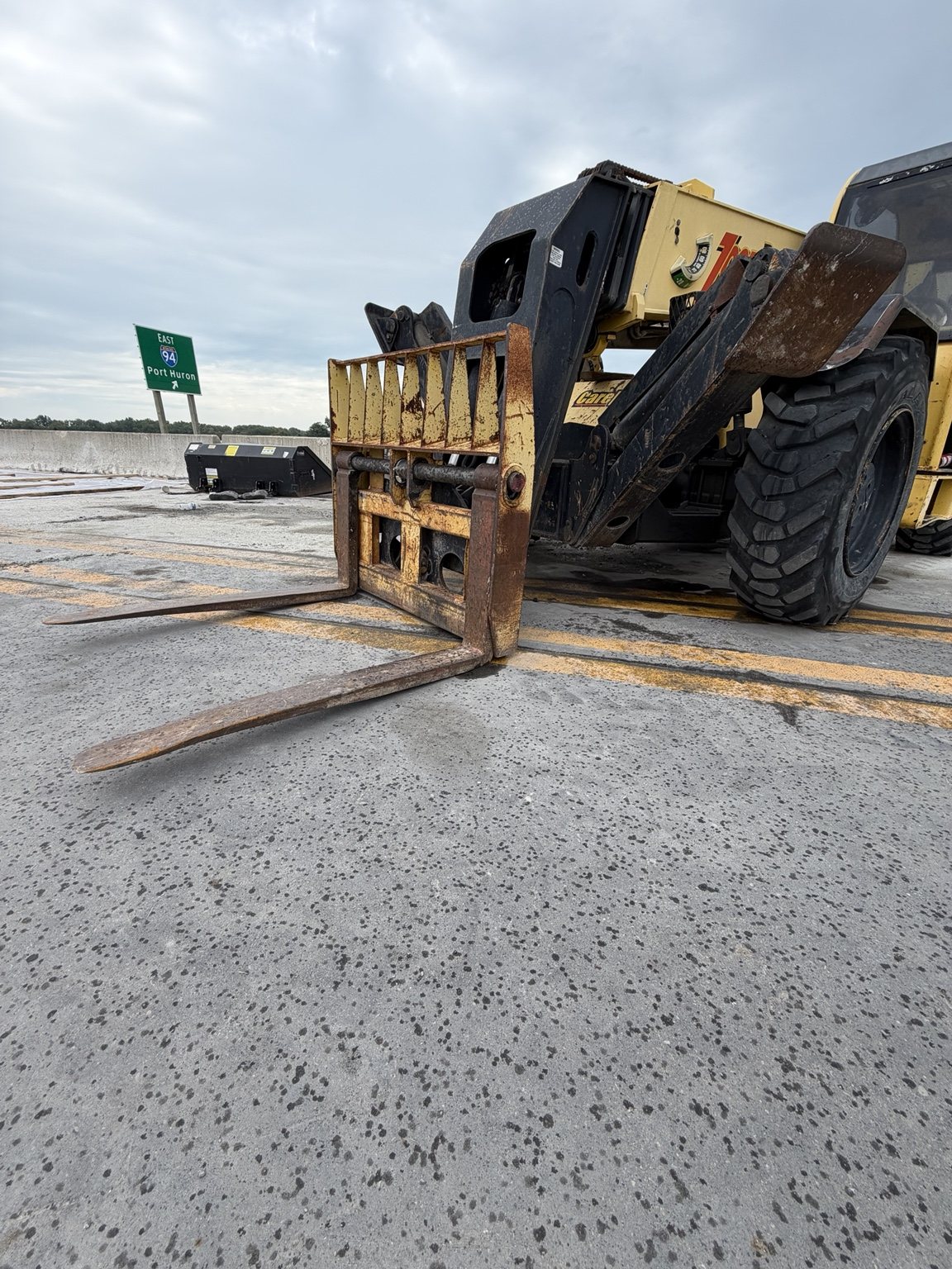 Full view of a telehandler with a significantly downward-bowed foreground fork
